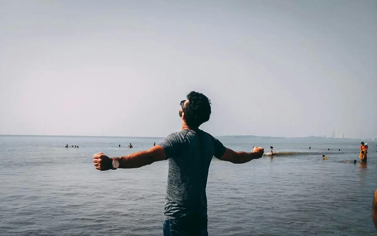 A stress-free property owner relaxing on the beach while receiving rental income notifications—Easy Host Services handles everything for you